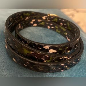 Genuine snakeskin and plated brass
Buckle closure
25" (L)